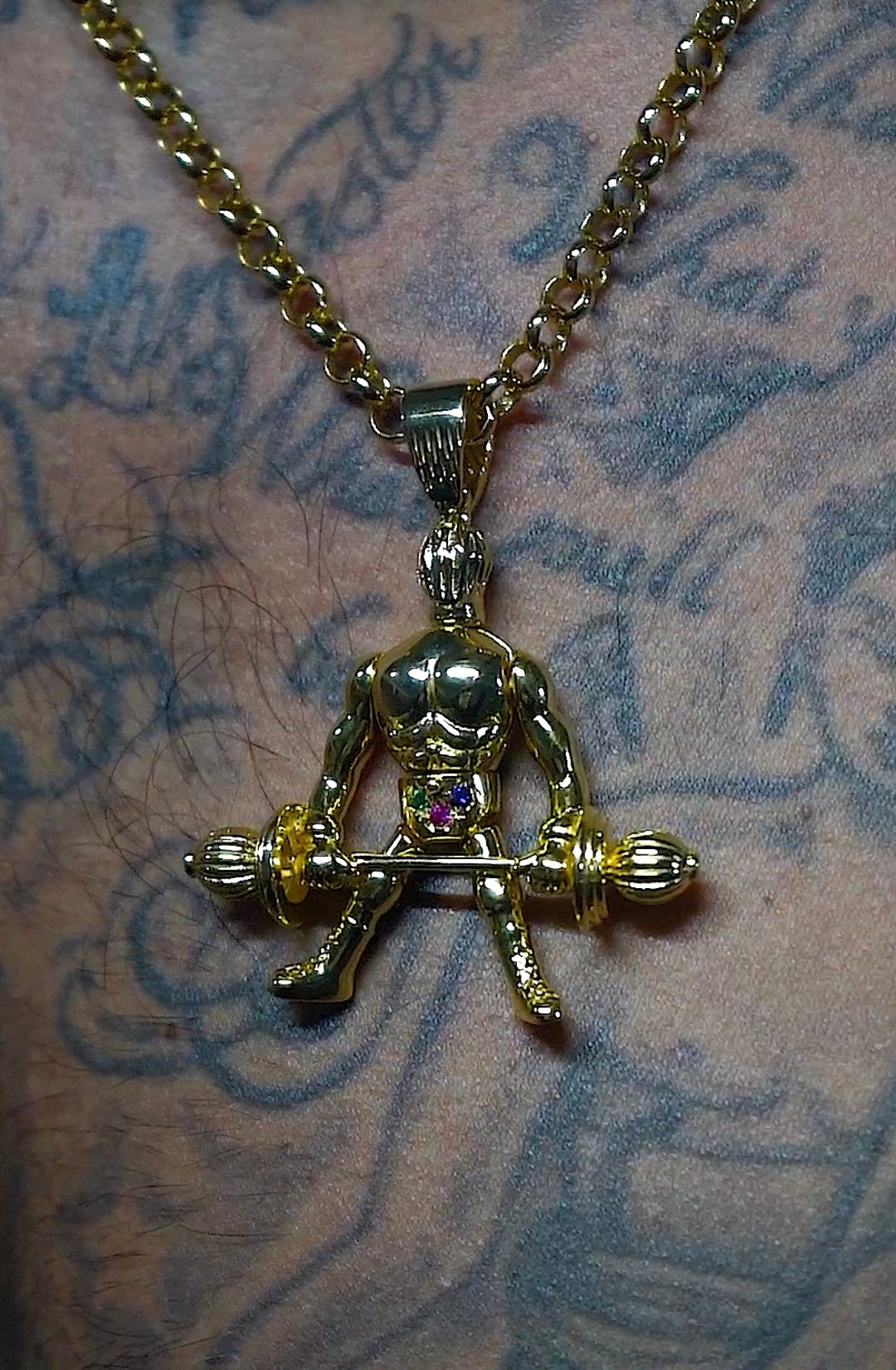 Close-up of Gold Filled Weightlifter Pendant with Stones