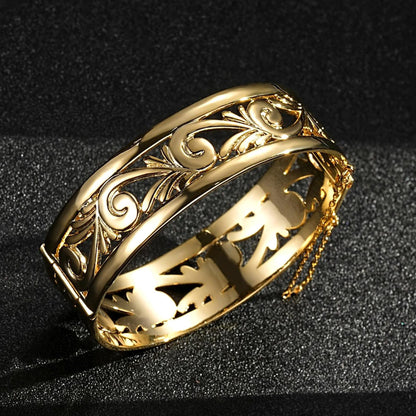 Chunky gold filigree bangle, 20mm wide, 46.5 grams, with safety chain.