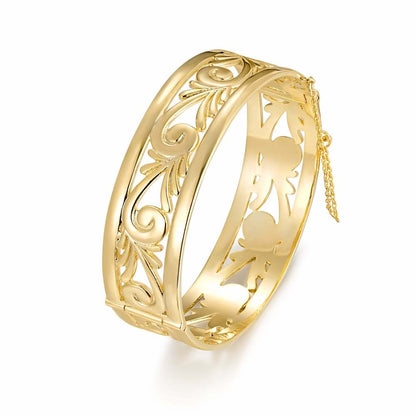 Chunky gold bangle with filigree design, 20mm width, 46.5 grams, safety chain.