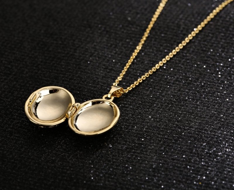 Opened gold oval locket showing interior space for a photo